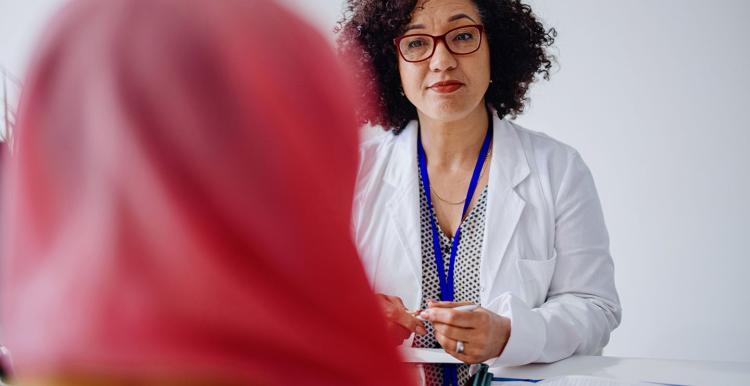 Female gynaecologist talking to her patient about cervical cancer awareness
