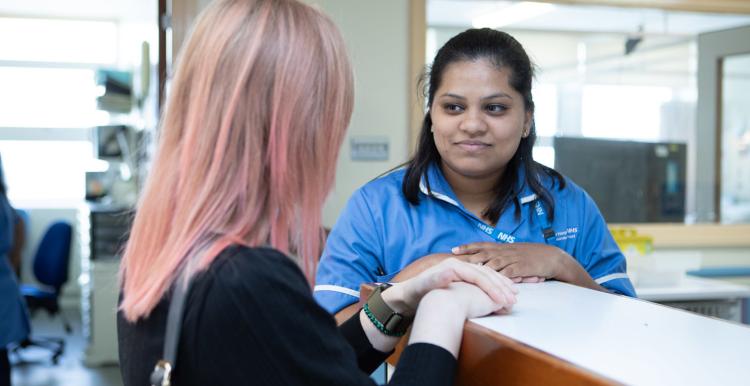 Woman talking to a female nurse