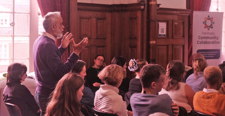 Asian man making a point about health inequality at a meeting in Islington Town  Hall