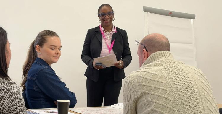 Three people talking at a Challenging Inequalities event 