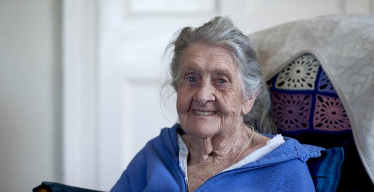 elderly lady sitting in a chair