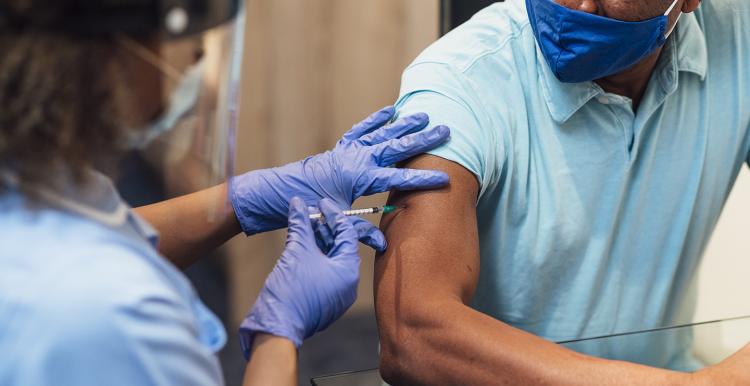 man having the covid vaccine