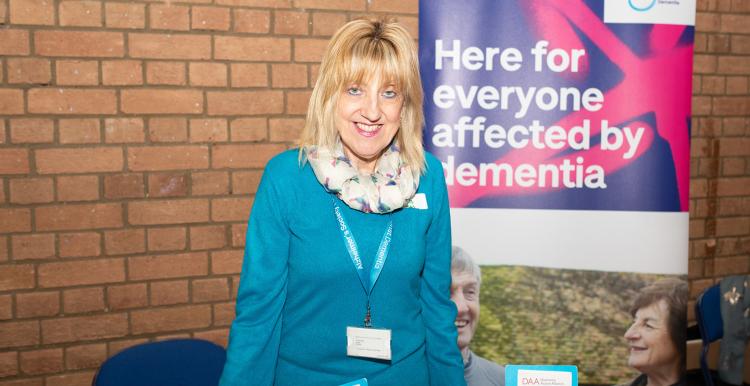 Woman at a stall offering support services