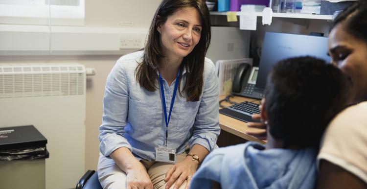 Female doctor with autistic child and his mother