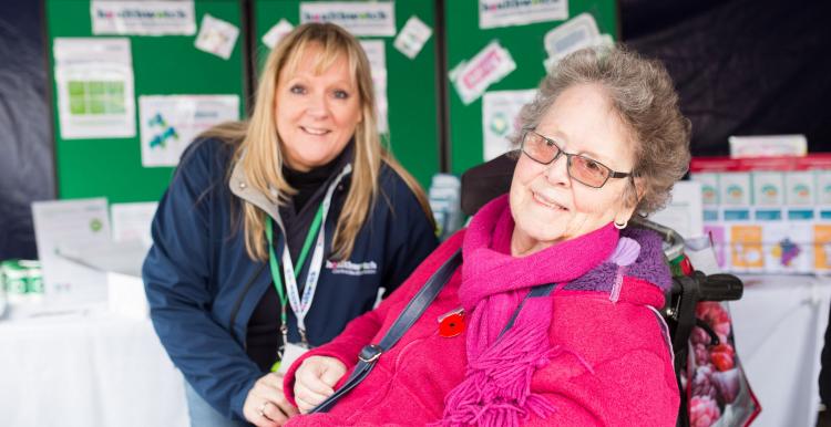 lady in wheelchair with carer in the background