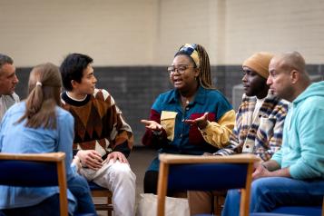 Group of adults sitting in a circle and talking to each other about their mental well-being