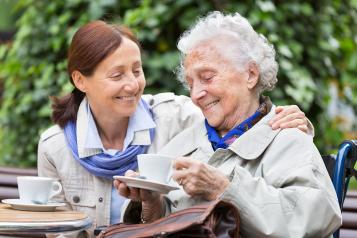 Smiling middle aged woman caring for her mother