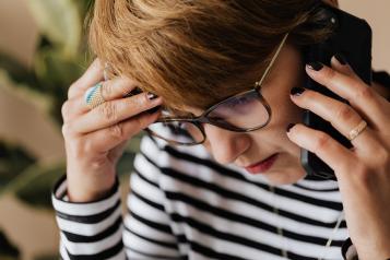 Anxious woman talking on the phone