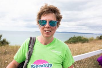 Woman in sunglasses attending an awareness raising event