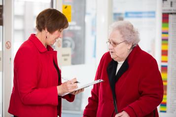 elderly woman in conversation with another woman