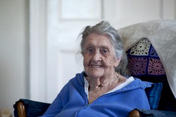 elderly lady sitting in a chair