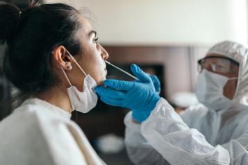 A woman having a lateral flow Covid test