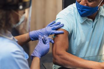 man having the covid vaccine