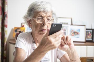 Older woman trying to use e-consult on her phone