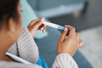 Woman taking a pregnancy test at home