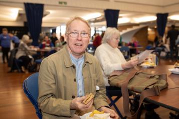 Smiling man with a sandwich