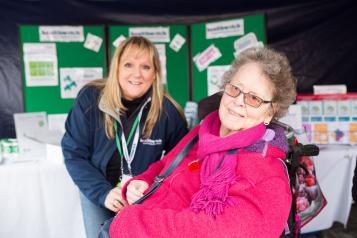 woman in wheelchair accompanied by a younger woman