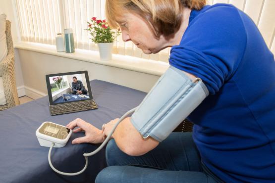 Patient communicates with her doctor via a laptop for advice Patient communicates with her doctor via a laptop for advice