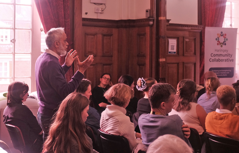 Asian man making a point about health inequality at a meeting in Islington Town  Hall